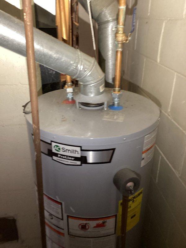 Performed ECI inspection of electrical panel and water heater installation. Panel inspection revealed multiple circuit breakers with somewhat disorganized wiring, including various colored conductors entering from the top. Water heater examination showed proper installation with appropriate ventilation ductwork and copper supply lines connected to the Smith unit.