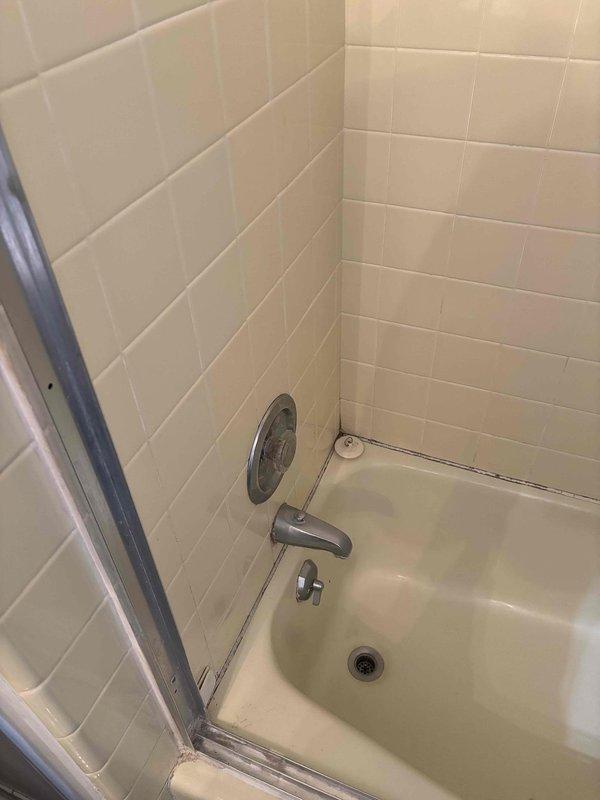 Replaced defective shower valve assembly that was causing stuck hot and cold handles. Inspected outdoor spigot during service visit and identified PVC supply line connection with proper purple primer at joints. All fixtures now operating correctly with smooth handle movement.