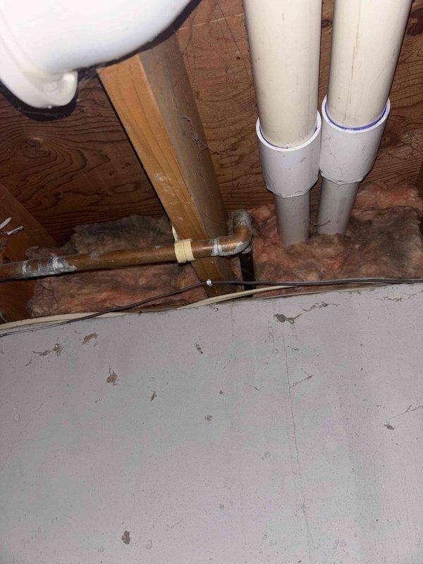 Replaced defective shower valve assembly that was causing stuck hot and cold handles. Inspected outdoor spigot during service visit and identified PVC supply line connection with proper purple primer at joints. All fixtures now operating correctly with smooth handle movement.