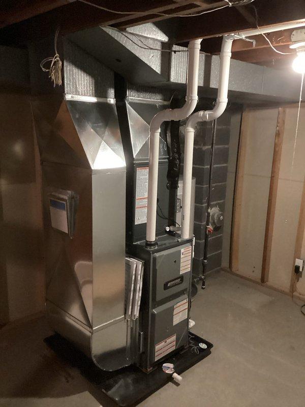 Successfully completed installation of new heating and cooling system including furnace with metal ductwork, air conditioning components, and water heater with proper copper piping connections. All units were professionally mounted with appropriate venting, and system was verified operational with all connections secure and properly insulated.