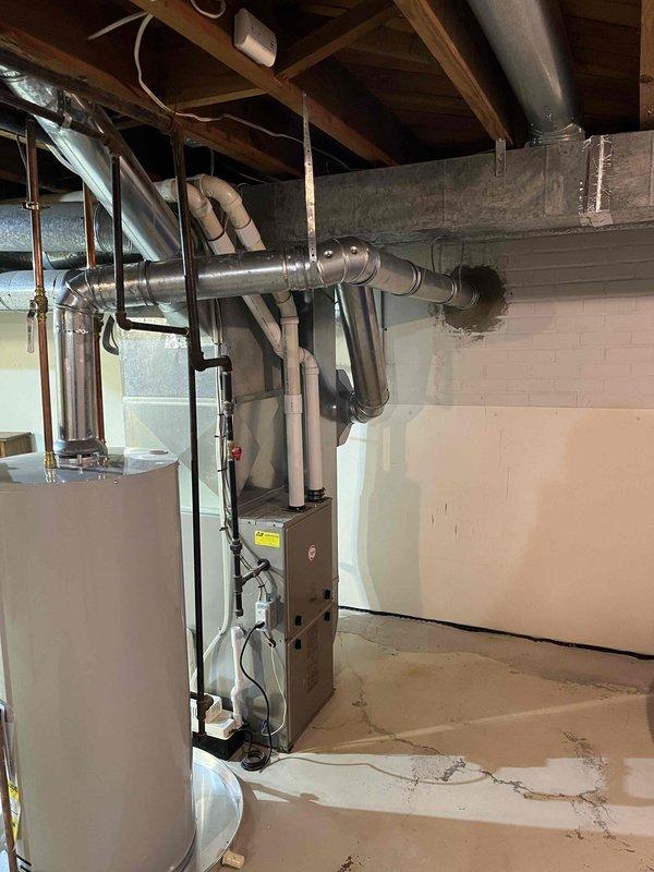 Corrected B-vent connector from water heater to existing chimney liner that was installed backwards, as indicated by flow direction arrow stamped on B-vent. Replaced improper single wall vent connection that was incorrectly screwed to male end of Hart and Cooley B-vent with manufacturer-approved listed chimney liner to B-vent connector per code requirements.