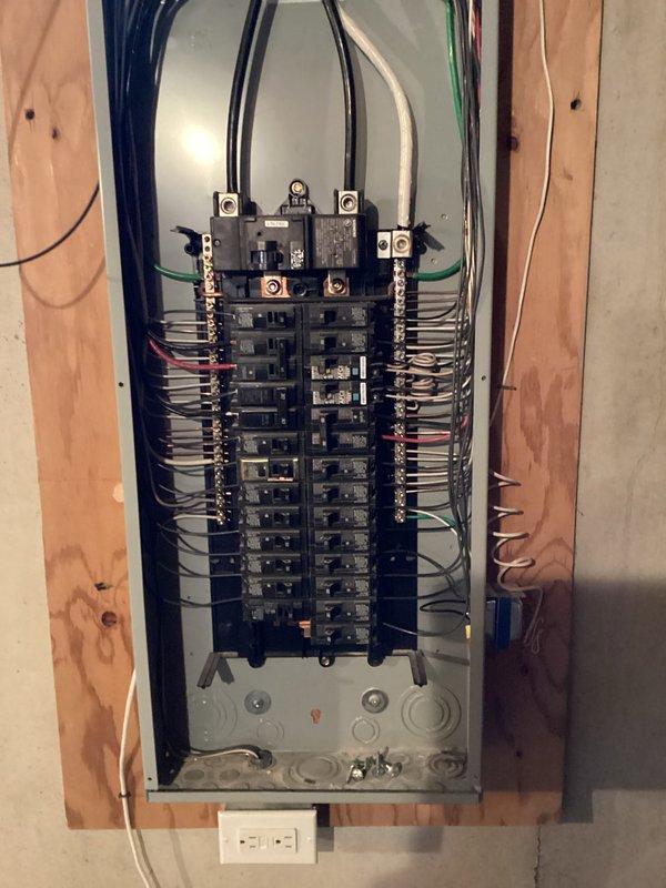 Completed ECI inspection of residential electrical system. Examined main circuit breaker panel with proper wiring connections and organization in unfinished area, and verified exterior meter installation with digital readout functioning properly. All components appear to be professionally installed with no visible code violations.