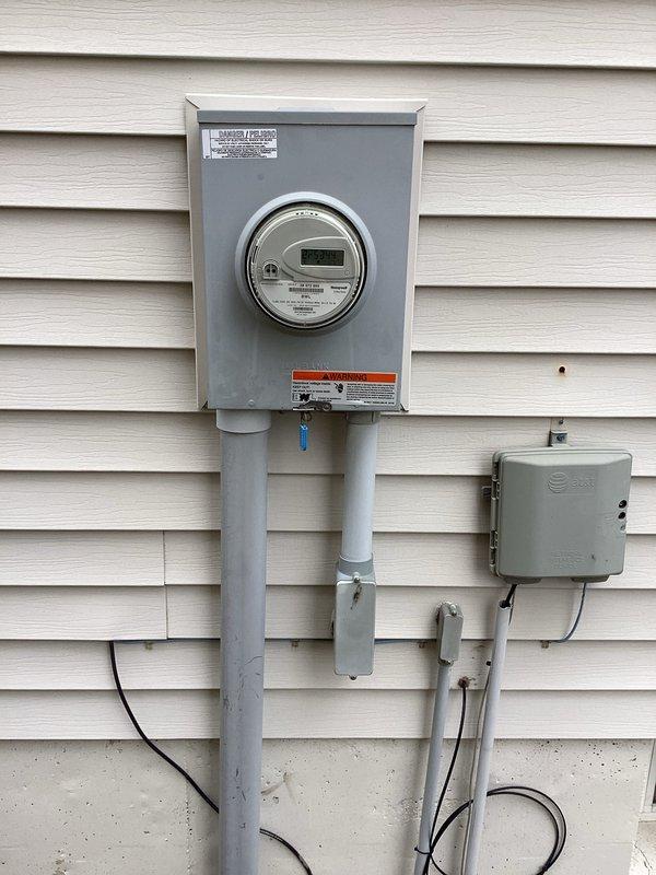 Completed ECI inspection of residential electrical system. Examined main circuit breaker panel with proper wiring connections and organization in unfinished area, and verified exterior meter installation with digital readout functioning properly. All components appear to be professionally installed with no visible code violations.