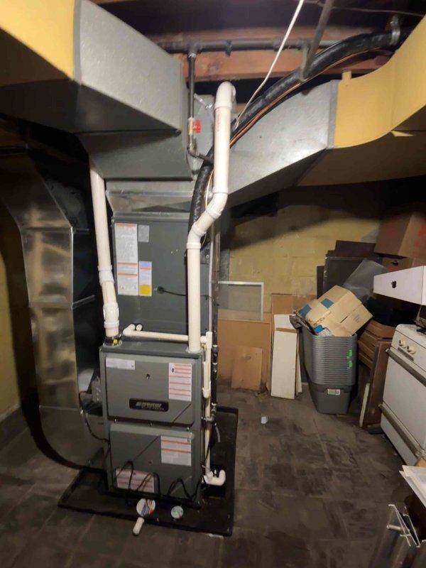 Successfully completed installation of an Airtek furnace and A/C system in basement utility area. Unit was properly mounted on a black platform with PVC drain pipes, flexible ductwork connections, and all required electrical connections. System was tested and verified operational per manufacturer specifications.
