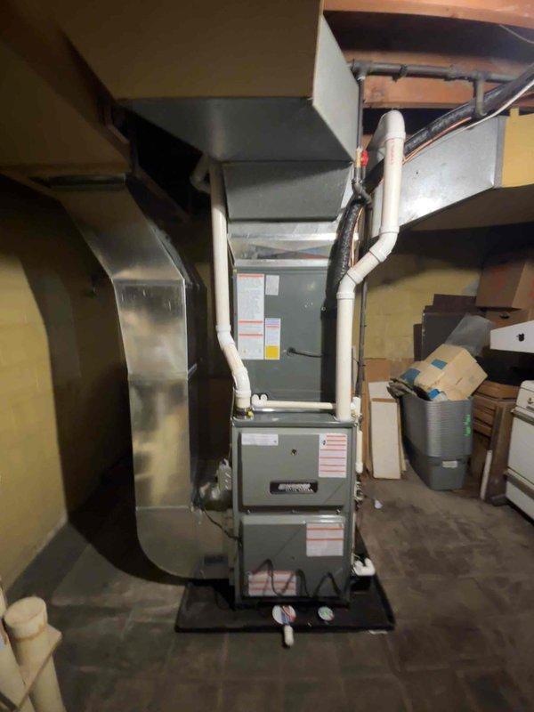 Successfully completed installation of an Airtek furnace and A/C system in basement utility area. Unit was properly mounted on a black platform with PVC drain pipes, flexible ductwork connections, and all required electrical connections. System was tested and verified operational per manufacturer specifications.