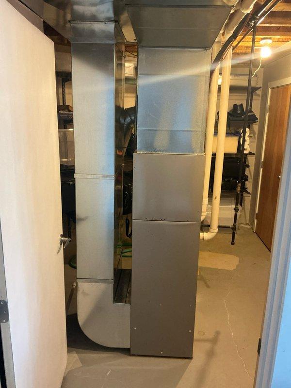 Completed comprehensive evaluation of existing Bryant HVAC system located in basement utility room. System includes furnace with attached humidifier, PVC drainage pipes, and metal ductwork throughout the space. Documented current installation configuration and ductwork layout to prepare accurate replacement estimate for new furnace and AC units as requested.