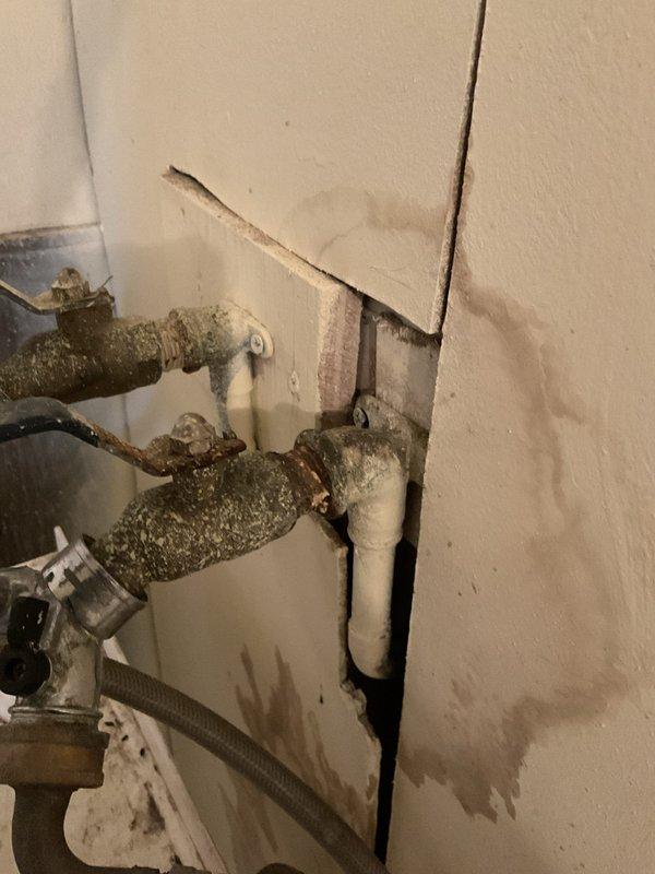 Identified and repaired a leaking pipe behind the sink with significant corrosion and mineral buildup. Replaced damaged sections of copper piping and valve assemblies that had caused water damage to the surrounding wall area, and restored proper water flow without leakage.