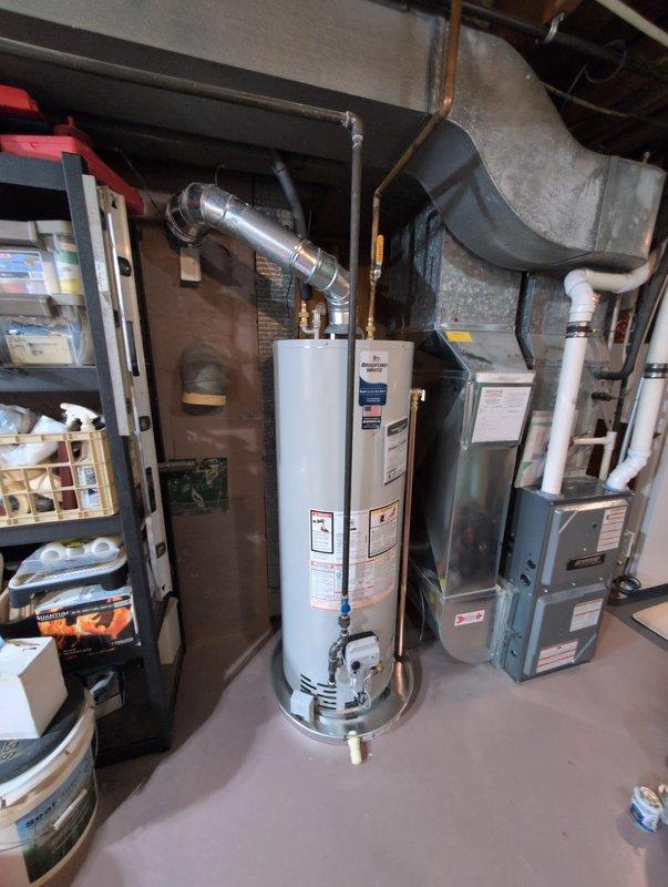 Successfully installed a 40-gallon natural gas tall water heater with direct vent configuration. Connected unit to existing gas line, water supply, and properly vented the system. Verified proper operation of safety controls including the electronic monitoring device mounted to the joist structure.