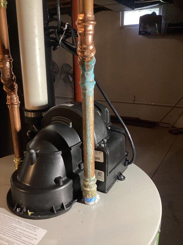 Responded to service call for leaking fitting on water heater. Inspected copper supply pipes and identified significant corrosion and active leak at connection point. Replaced damaged section of pipe and fitting, ensuring proper seal and connection integrity. System now functioning properly with no signs of leakage.