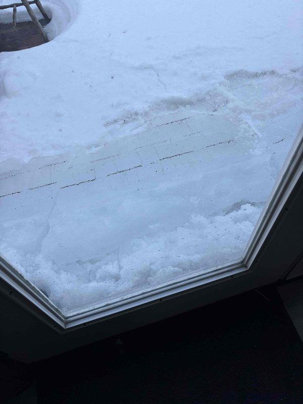 Inspected outdoor AC unit damaged by falling icicle. Unit is 0 years old with model ENE WT 7-2030. Documented damage with photos showing snow accumulation around the unit and surrounding area. Customer was informed of findings.