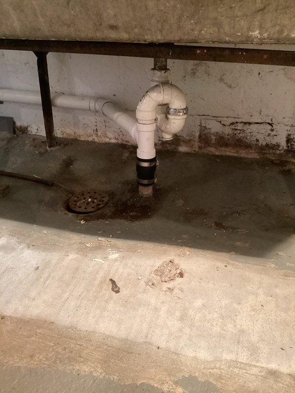 Successfully installed a dedicated laundry standpipe by connecting to the existing utility sink drain using a sanitary tee fitting. Properly secured vertical PVC drain pipe to wall with mounting brackets and configured appropriate P-trap assembly to ensure proper drainage and venting per code requirements.