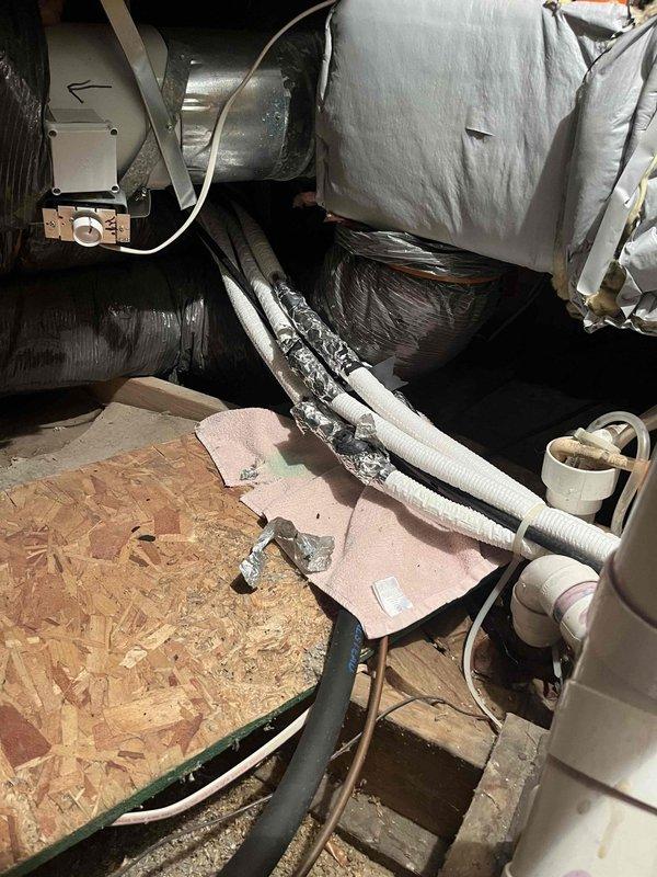 Performed diagnostic assessment on 9-year-old mini-split system in Room 2 that has required multiple refrigerant charges. Inspection of crawl space revealed deteriorated ductwork insulation and compromised connections at several junction points. Determined system's slow heating/cooling performance is due to significant refrigerant leak requiring comprehensive repair rather than continued recharging.