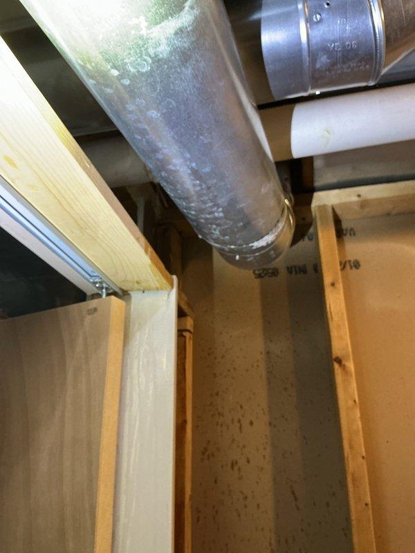Responded to service call for tub leak. Inspection revealed condensation on metal HVAC ductwork in basement area, with visible water droplets forming on the main duct surface. Confirmed proper placement of plumbing components and resolved the moisture issue.