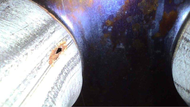 Performed annual tune-up on 10-year-old Goodman furnace. Inspection revealed significant corrosion and perforation in the heat exchanger, including a hole with surrounding rust damage. Documented evidence of metal deterioration with photos for customer records.