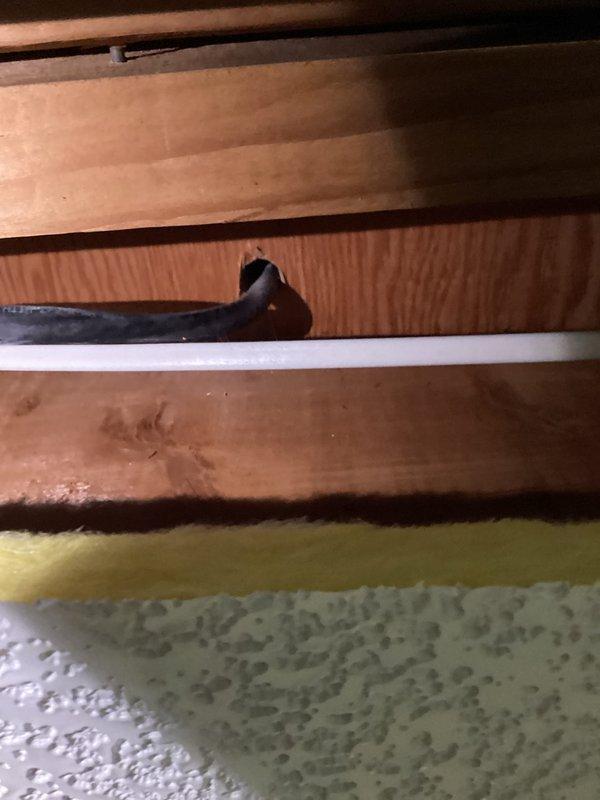 Conducted site assessment for installing gas line to accommodate new gas range. Inspected existing structural components and photographed the area where gas line will need to pass through wooden joists. Examined electrical panel to verify capacity and document current circuit configuration, noting existing "STOVE" circuit that will be relevant to the installation plan. Client contact information documented for follow-up.