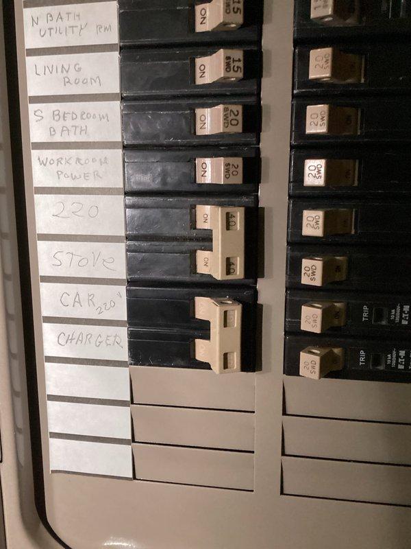 Conducted site assessment for installing gas line to accommodate new gas range. Inspected existing structural components and photographed the area where gas line will need to pass through wooden joists. Examined electrical panel to verify capacity and document current circuit configuration, noting existing "STOVE" circuit that will be relevant to the installation plan. Client contact information documented for follow-up.