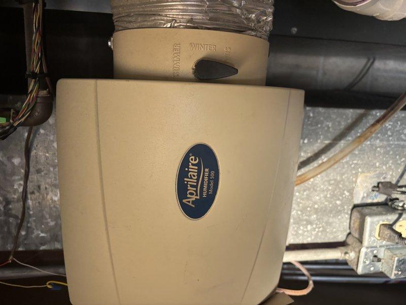 Performed annual heating system maintenance on 16-year-old furnace with integrated Aprilaire humidifier. Inspected copper plumbing connections showing normal oxidation and verified proper operation of valve handles despite visible wear. Humidifier was functioning correctly with appropriate ducting connections and control settings adjusted for winter operation.
