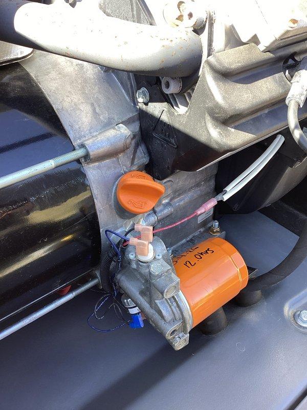 Performed scheduled 2-year tune-up on Honeywell generator (WT model, warranty through 08/2030). Inspected electrical connections and verified proper resistance readings (12 ohms) at the orange cylindrical component. Confirmed all mechanical systems were in good working order and documented condition of internal components including motor assembly and HOT box.