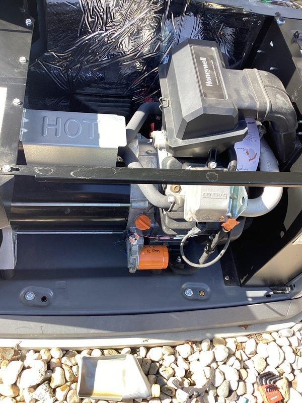 Performed scheduled 2-year tune-up on Honeywell generator (WT model, warranty through 08/2030). Inspected electrical connections and verified proper resistance readings (12 ohms) at the orange cylindrical component. Confirmed all mechanical systems were in good working order and documented condition of internal components including motor assembly and HOT box.