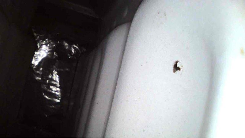 Responded to service call for a Carrier furnace displaying error code 31. Upon inspection of the 12-year-old unit in a confined space, found the furnace was still operational despite the error code. Documented the condition with photos of the interior components and surrounding mechanical space for future reference.