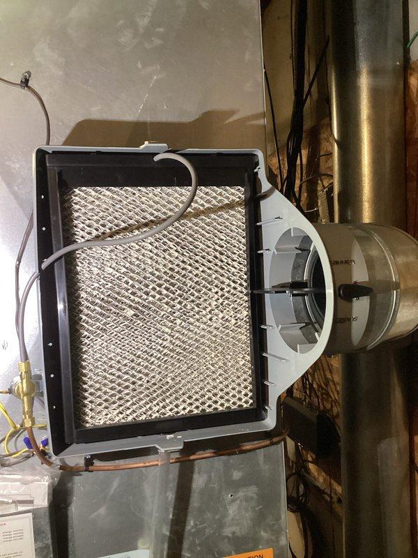Completed furnace and humidifier tune-up service as part of maintenance agreement. Inspected and cleaned air filter components showing good condition with no significant clogging. Humidifier system was serviced with filter showing normal usage wear but functioning properly.