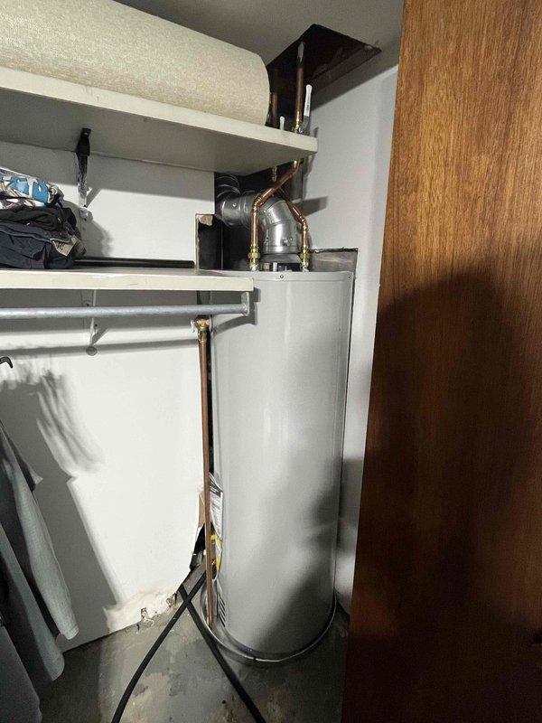 Successfully installed new water heater in utility area, connecting all required copper pipes and fittings. Properly secured ventilation ductwork with appropriate 90-degree bend for exhaust. Confirmed all connections are leak-free and unit is functioning according to manufacturer specifications.