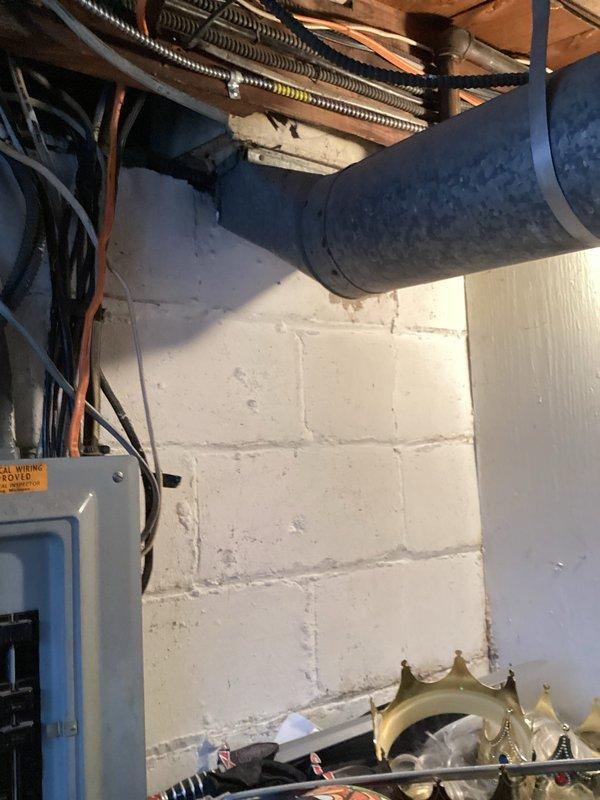 Performed site assessment to verify previously submitted quotes. Inspected electrical infrastructure including multiple utility boxes mounted on exterior siding and electrical panel in basement mechanical area. Documented existing conditions with photos showing utility connections, exposed ductwork, and seasonal debris accumulation around foundation for comprehensive evaluation.