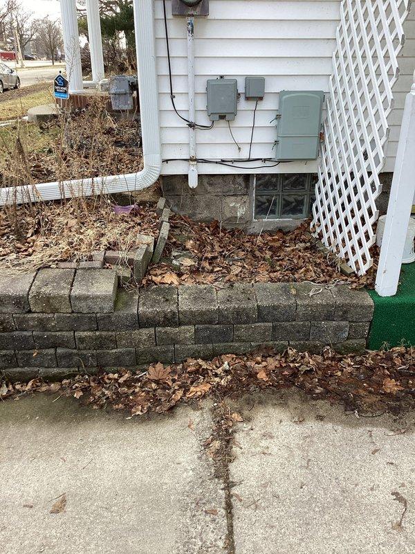 Performed site assessment to verify previously submitted quotes. Inspected electrical infrastructure including multiple utility boxes mounted on exterior siding and electrical panel in basement mechanical area. Documented existing conditions with photos showing utility connections, exposed ductwork, and seasonal debris accumulation around foundation for comprehensive evaluation.