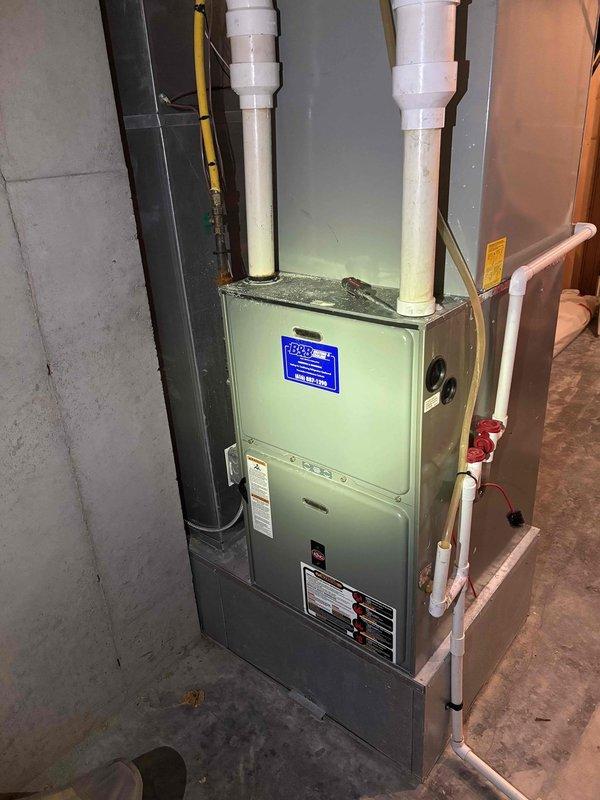 Completed annual heating maintenance service on 3-year-old Reznor furnace per Comfort Club membership. Performed comprehensive tune-up with no issues found. System is operating correctly with proper venting through PVC exhaust pipes, and all connections including copper lines and shut-off valves are secure and in good condition.