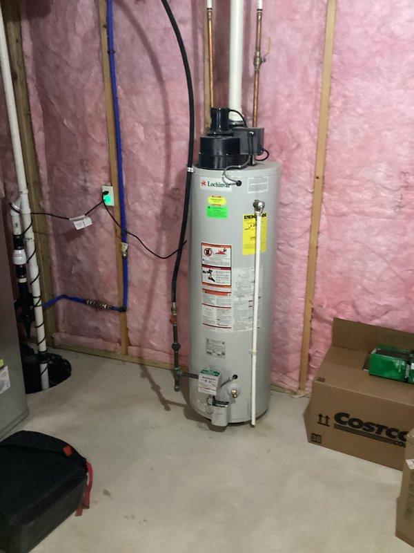Conducted a water heater replacement estimate for a 15-year-old, 40-gallon Lochinvar unit that client reported is functioning but inefficient. Inspection revealed the existing water heater is installed in basement utility area with proper copper piping connections and electrical components. Documented current installation configuration including plumbing layout and available space to facilitate accurate quote for a more energy-efficient replacement system.