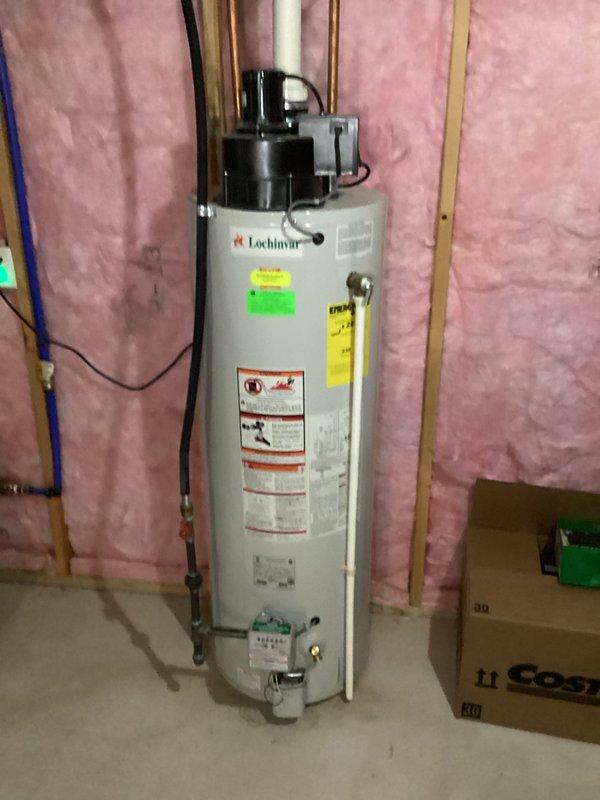 Conducted a water heater replacement estimate for a 15-year-old, 40-gallon Lochinvar unit that client reported is functioning but inefficient. Inspection revealed the existing water heater is installed in basement utility area with proper copper piping connections and electrical components. Documented current installation configuration including plumbing layout and available space to facilitate accurate quote for a more energy-efficient replacement system.