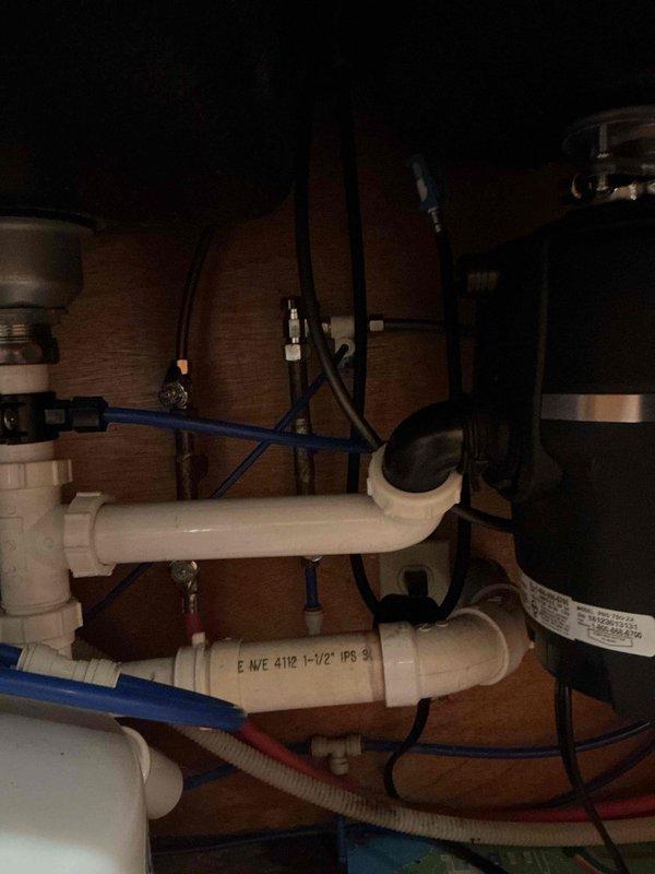 Diagnosed and repaired a slow leak originating from the main kitchen faucet, which was initially thought to be coming from the adjacent reverse osmosis system. Inspected under-sink plumbing components, including PVC drain pipes and supply lines, and found no issues with the RO system connections. Completed necessary repairs to resolve the leak at the faucet assembly.