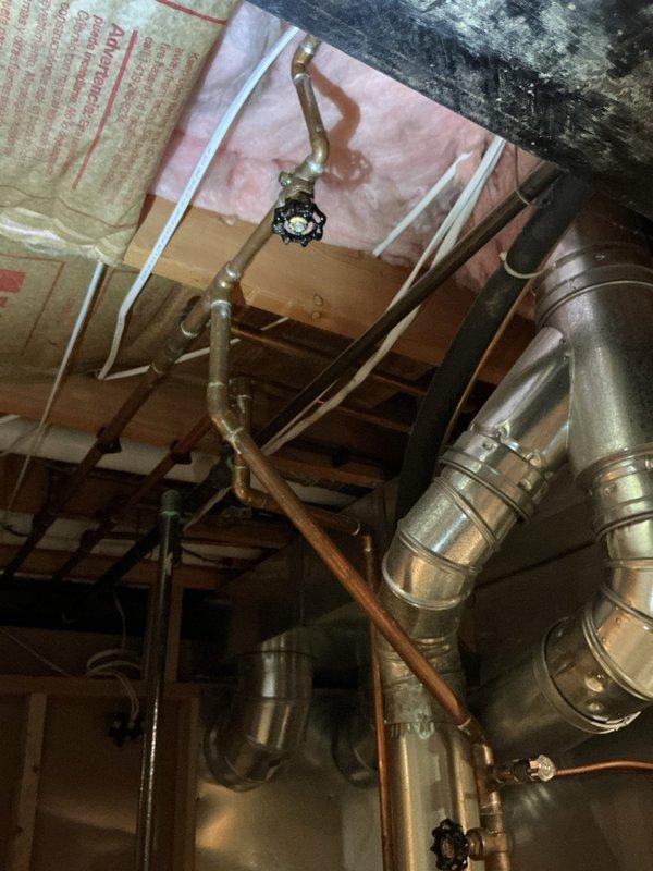 Investigated leak near water heater in basement utility area. Identified and repaired copper pipe connection issue at shut-off valve junction. Tested system after repair to confirm proper operation with no further leakage.