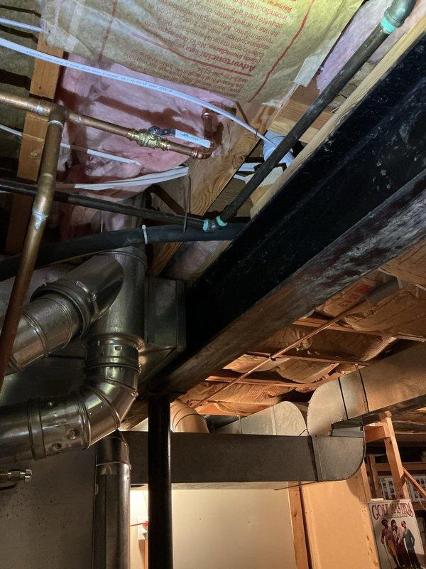 Investigated leak near water heater in basement utility area. Identified and repaired copper pipe connection issue at shut-off valve junction. Tested system after repair to confirm proper operation with no further leakage.