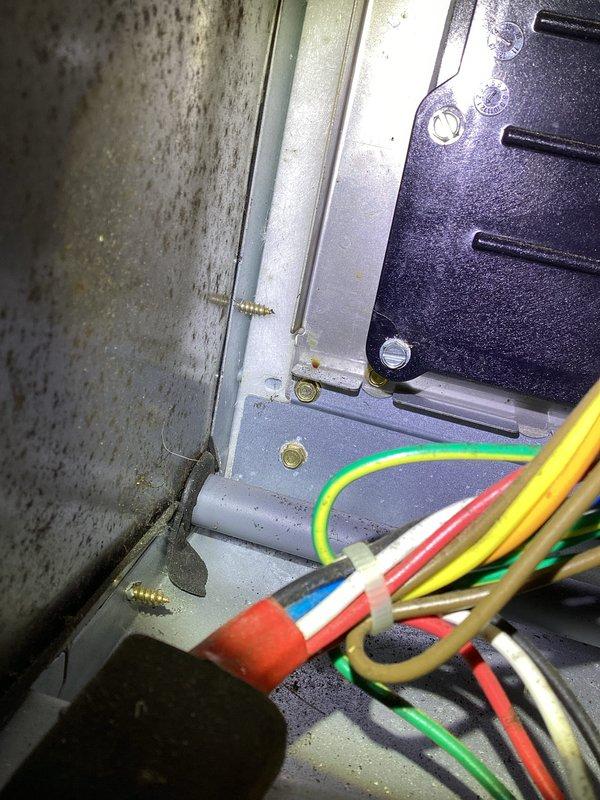 Performed annual tune-up on 14-year-old Carrier furnace with humidifier. Identified mold growth and dust accumulation on interior components, with visible moisture damage to electrical connections and mounting hardware. Equipment shows significant wear consistent with age and requires monitoring for safe operation.