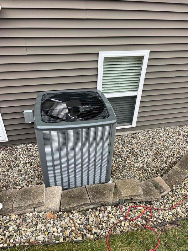 Performed complete installation of new furnace and air conditioning system. New AC condenser was properly installed on gravel bed with concrete paver retaining wall for stability. Indoor furnace unit was installed in basement with appropriate PVC ventilation system and all necessary electrical connections completed.
