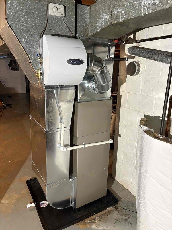 Successfully installed new HVAC system including Carrier outdoor AC unit positioned on concrete pad and AirEase furnace with integrated humidifier in utility area. Complete installation included all necessary ductwork connections and system testing to ensure proper functionality.