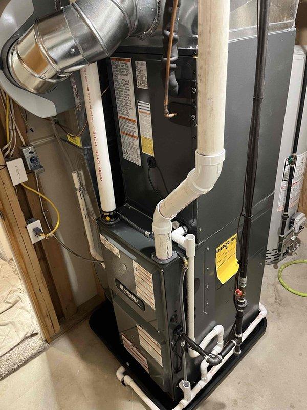 Successfully completed full system replacement with installation of new furnace and AC unit. Interior furnace was properly mounted in utility area with all required connections (ductwork, PVC ventilation, copper lines, and drainage) while exterior condenser was securely installed on concrete pad with appropriate electrical connections to the home.