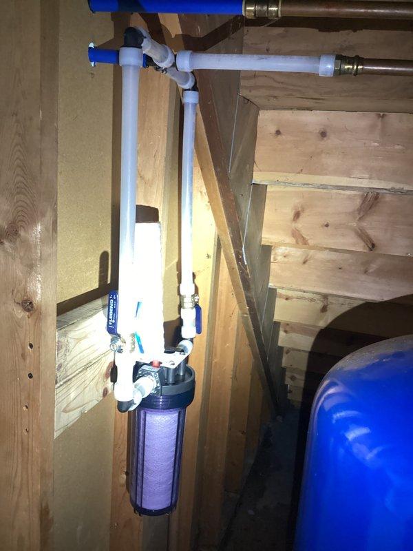 Completed installation of whole home water filter system in basement utility area, properly connecting to existing copper and PVC plumbing infrastructure. Replaced severely corroded toilet flange and installed new toilet as quoted, ensuring proper seal and function.