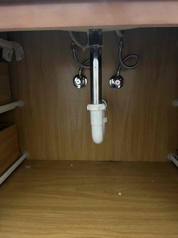 Completed quoted repair involving replacement of two faucets and installation of two new shut-off valves. Removed deteriorated drain assembly that showed significant mineral buildup and discoloration. Work included accessing and replacing the under-sink plumbing components, ensuring proper water supply connections with the newly installed hardware.