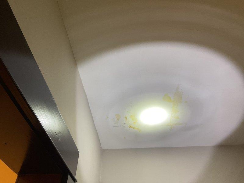 Responded to a service call for water leakage from a second-floor bathroom causing ceiling damage and staining around a recessed light fixture below. Upon inspection, identified a deteriorated faucet cartridge with mineral buildup and damaged seals as the source of the leak. Removed and replaced the faulty cartridge to resolve the issue.