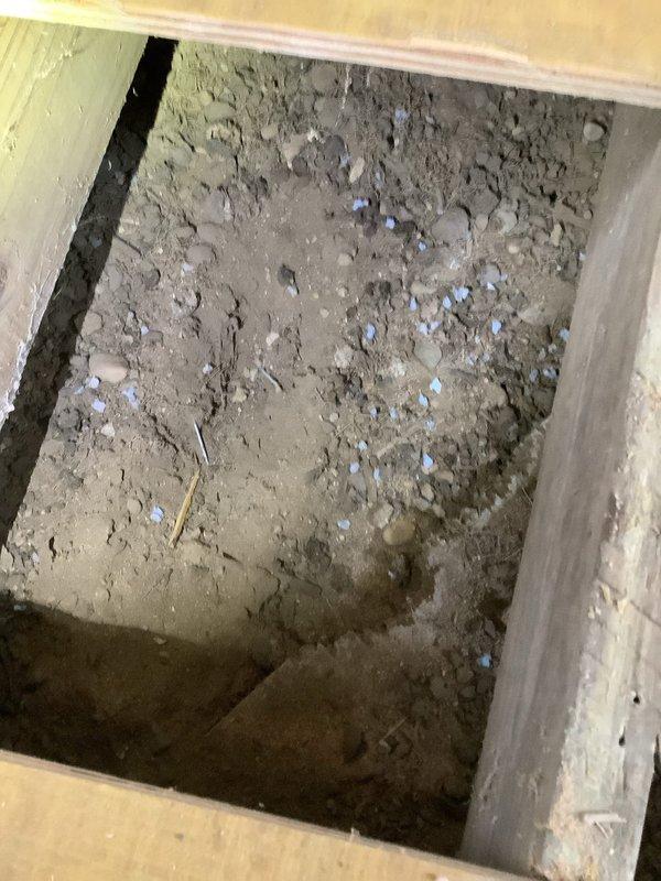 Conducted a site assessment for installation of new bathroom and laundry facilities on the main floor, documenting a floor access point with exposed soil/gravel substrate and an existing water heater with severely deteriorated adjacent piping showing extensive alligator cracking and outer coating failure. Coordinated with comfort advisor regarding mini-split or alternative heat source options for the space.