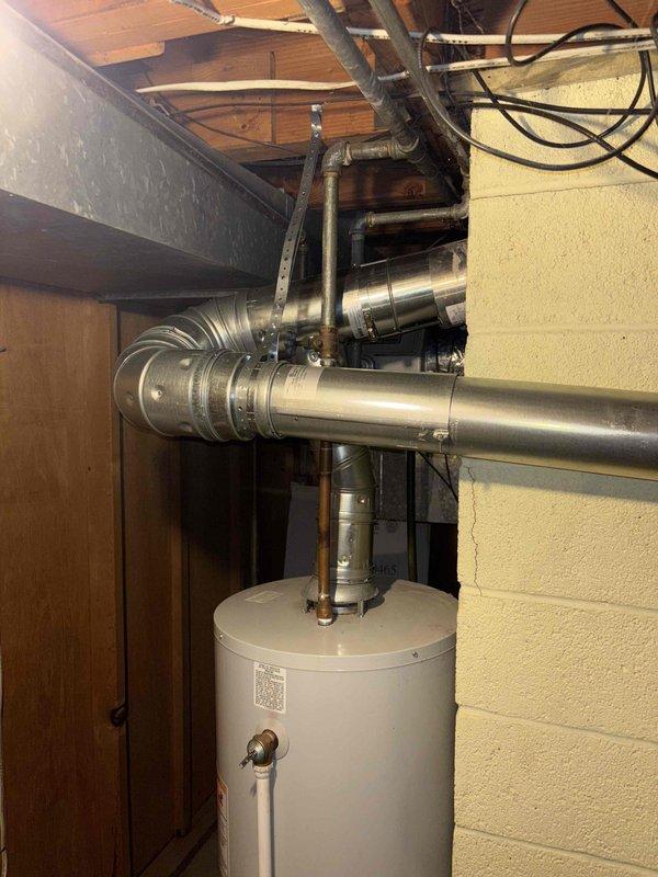 Conducted comprehensive inspection of basement mechanical room housing water heater and HVAC system. Examined ducting, plumbing connections, and electrical wiring for proper installation and potential issues. Documented condition of equipment with photos showing normal operating state with no visible damage, rust, or leakage.