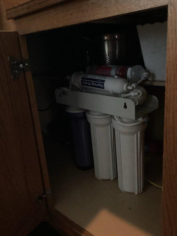 Diagnosed and serviced an iSpring F9K water filtration system that was experiencing severely reduced flow. Replaced primary filter element and discovered issue with refrigerator water line connection. System continues to produce inadequate water pressure despite filter replacement, indicating potential upstream blockage or pressure regulator malfunction. Further service recommended to restore proper functionality.