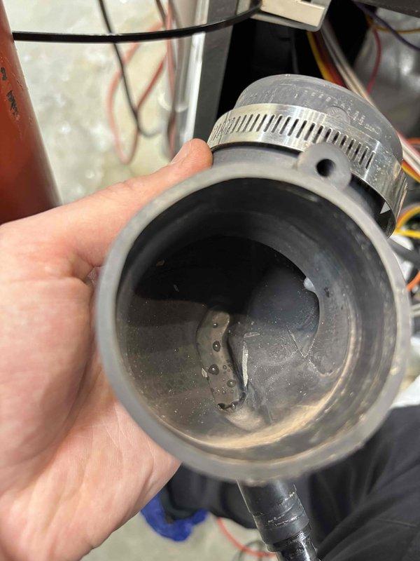 Responded to no-heat call for 7-year-old EnergiAir system (model WT 10-2028). Inspection revealed significant debris buildup in the condensate drain line with a blocked drain trap, causing system shutdown. Cleared obstruction, cleaned trap assembly, and verified proper system operation before departure.