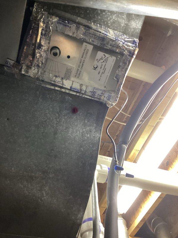 Performed annual furnace tune-up as part of Comfort Club membership on 8-year-old Lennox system. Inspected ceiling-mounted HVAC components and ductwork, noting all connections properly sealed with foil tape. Examined humidifier mounted on ductwork with PVC connection; system appears to be functioning properly with no issues identified.