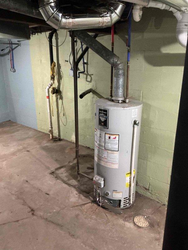 Conducted plumbing project estimate for installation of washer and dryer in basement, which requires relocation of existing attic plumbing vent. Assessment included evaluation of current water heater venting system which needs modification to meet code requirements. Documented existing HVAC setup, water heater configuration, and current plumbing infrastructure with photos to develop comprehensive project plan.