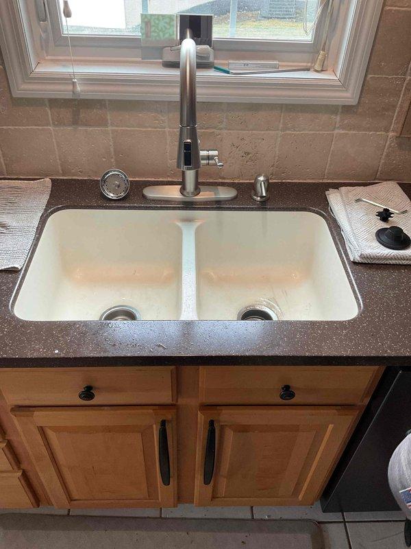 Completed quoted repair work on main floor, focusing on kitchen sink area. Performed necessary repairs to the double-basin white undermount sink and surrounding cabinetry. Work was completed within the scheduled 4-hour timeframe, with documentation photos taken to verify completed service.