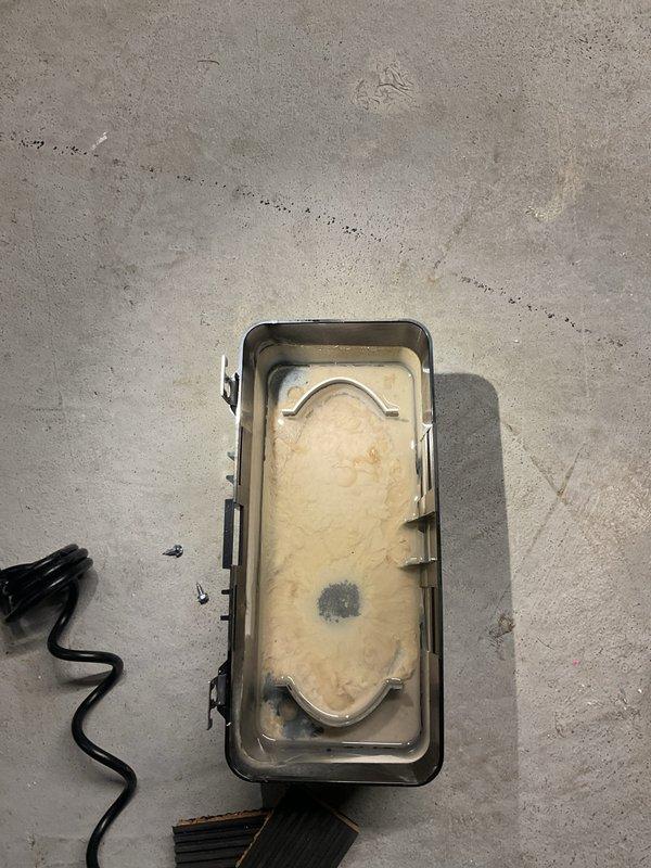 Performed annual heating maintenance on furnace and humidifier system. Removed and cleaned condensate collection container which showed signs of buildup and discoloration. Inspected and cleaned housing component with visible residue and water marks, ensuring proper system operation.