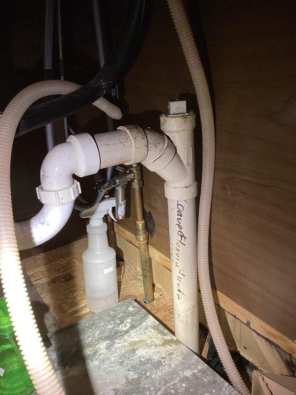 Conducted comprehensive assessment for kitchen remodel estimate, inspecting existing PVC drainage system with multiple pipe sections and associated brass fittings. Evaluated structural framework in crawlspace/between floor joists, documenting condition of plumbing infrastructure and electrical wiring pathways to determine scope of work required for renovation project.